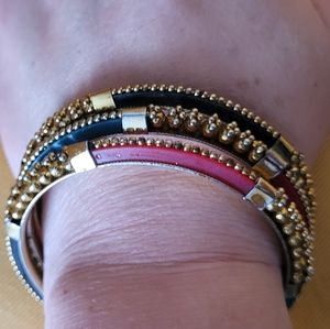 Set of 3 bangle bracelets goldtone with blye, black & red acrylic